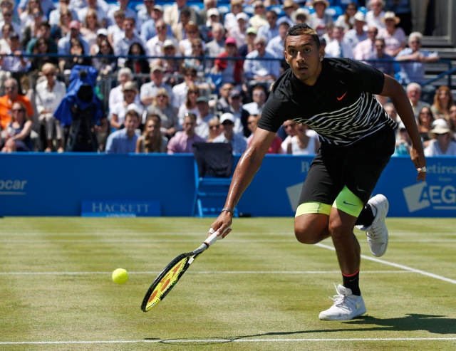 Australia's Nick Kyrgios runs to play a shot during his match against Switzerland's Stan Wawrinka on the second day of the ATP Aegon Championships tennis tournament at the Queen's Club in west London on June 16, 2015. Wawrinka won the match 6-3, 6-4. AFP PHOTO / ADRIAN DENNIS / AFP / ADRIAN DENNIS